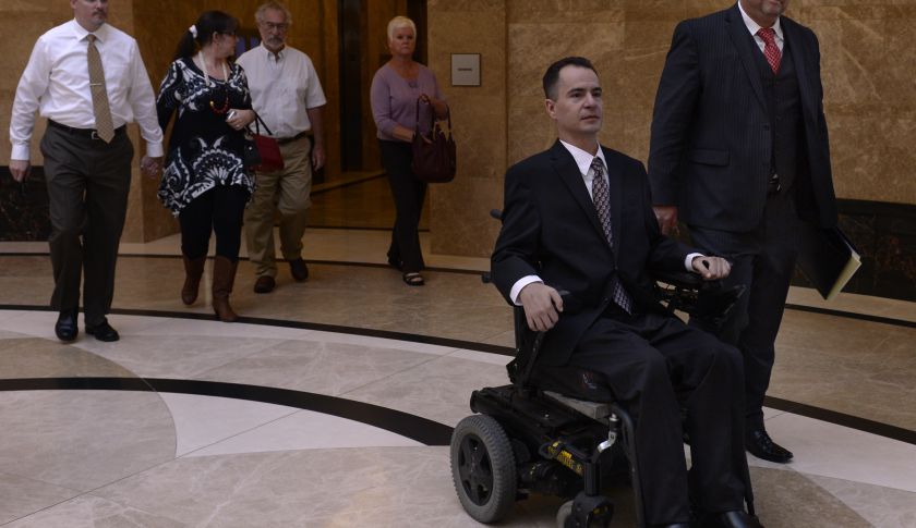 Brandon Coats leaves the courthouse at the end of the hearing with his attorney Michael Evans, right. The Colorado Supreme Court listens to arguments in the case of Brandon Coats, a quadriplegic medical marijuana patient who was fired from his job at Dish Network after testing positive for marijuana. Photograph by Kathryn Scott — Osler Denver Post via Getty Images
